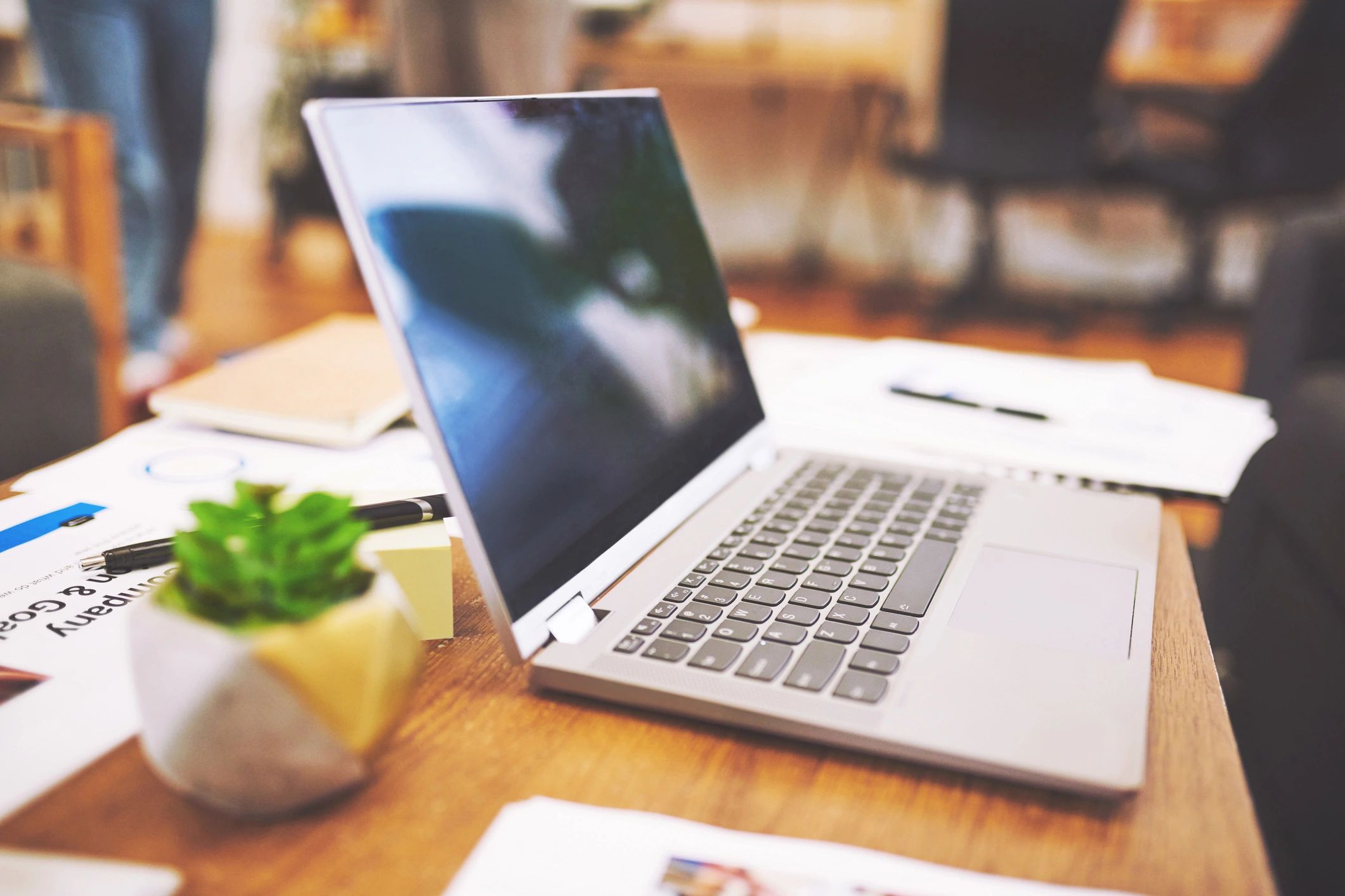 Elegant workspace with laptop and papers representing intentional legacy building