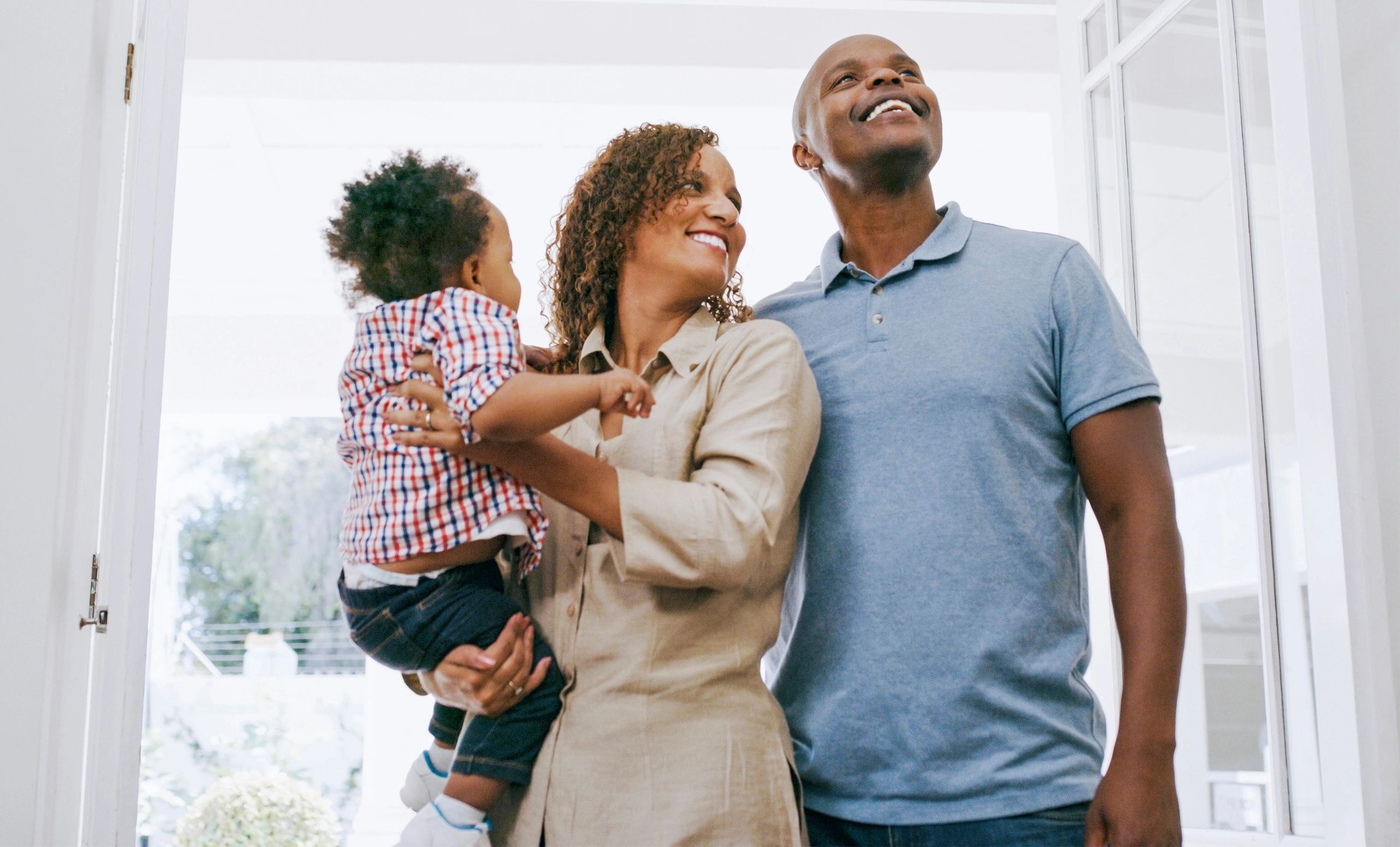 Young family at a new home representing future security