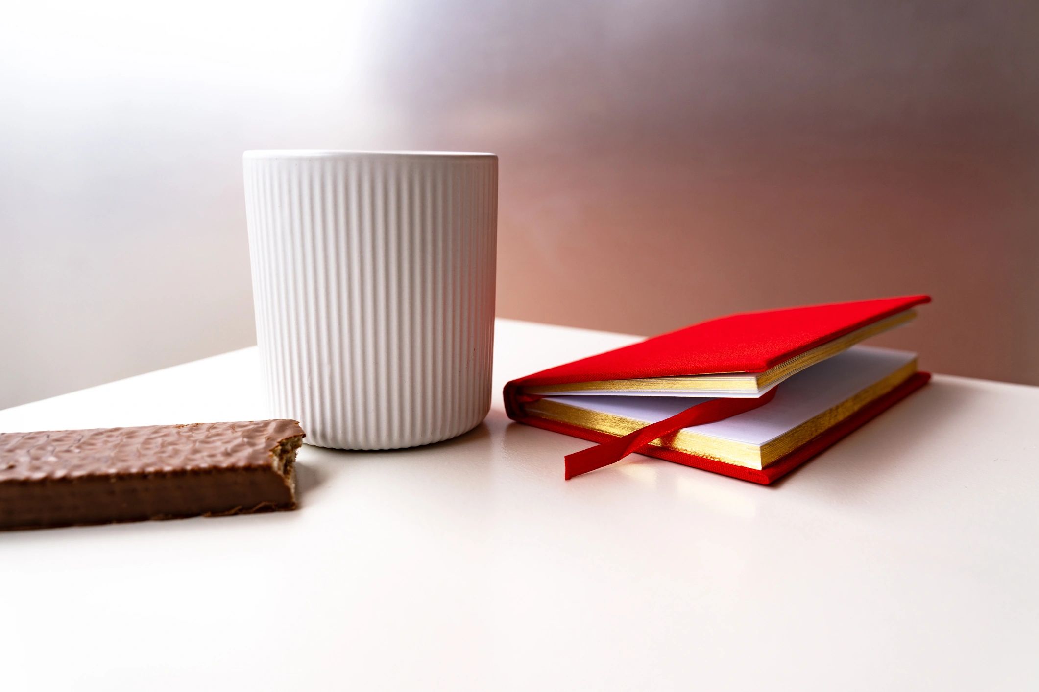 Minimal coffee and book flat lay representing thoughtful daily rituals